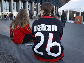 Ottawa Senators fans arrive for Wednesday's game at the Canadian Tire Centre after making changes to their Brady Tkachuk jerseys.