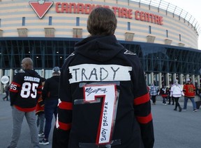 Ottawa Senators fans arrive for Wednesday's game at the Canadian Tire Centre after making changes to their Brady Tkachuk jerseys.