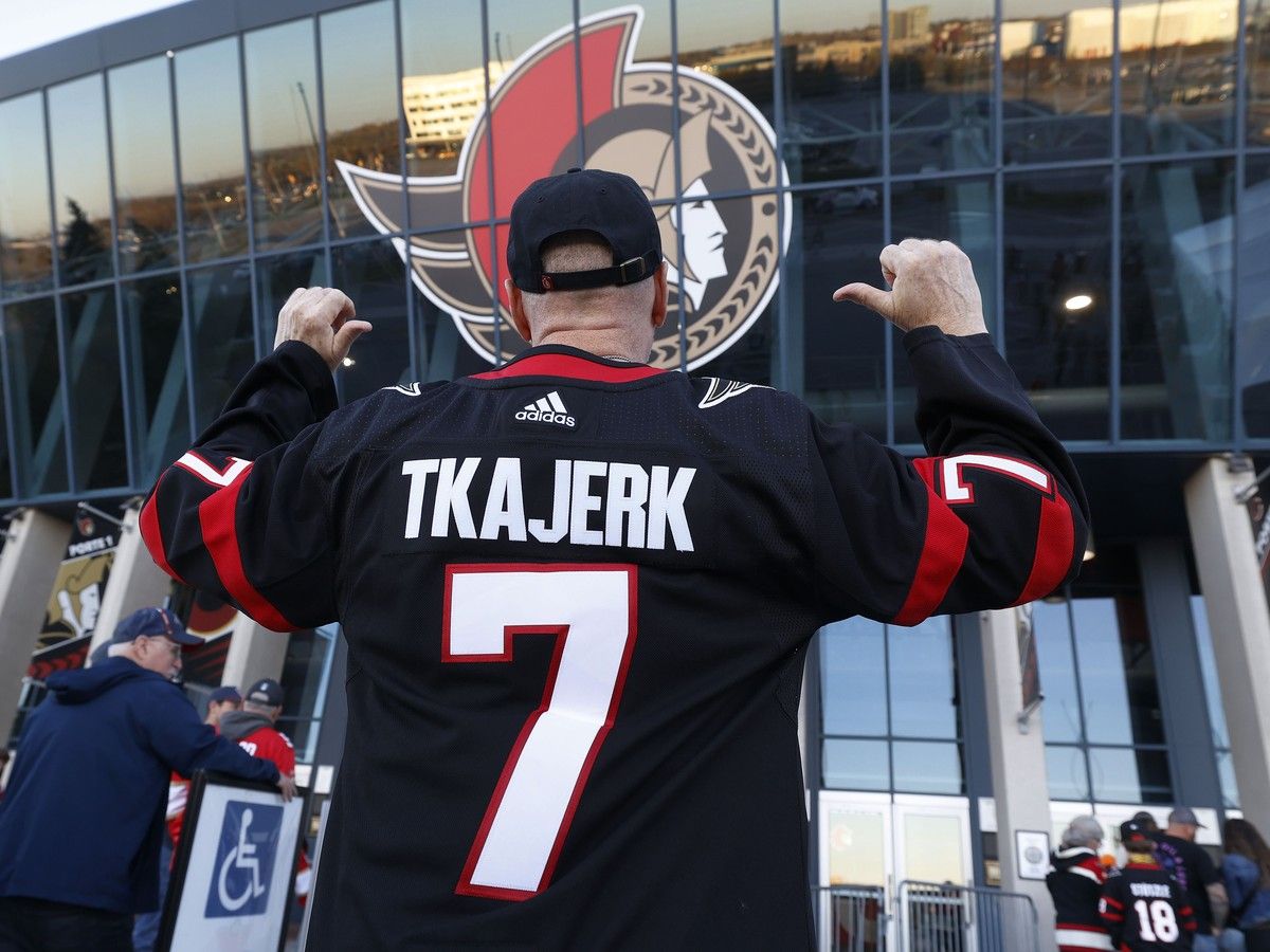 Ottawa Senators fans arrive for Wednesday's game at the Canadian Tire Centre after making changes to their Brady Tkachuk jerseys.
