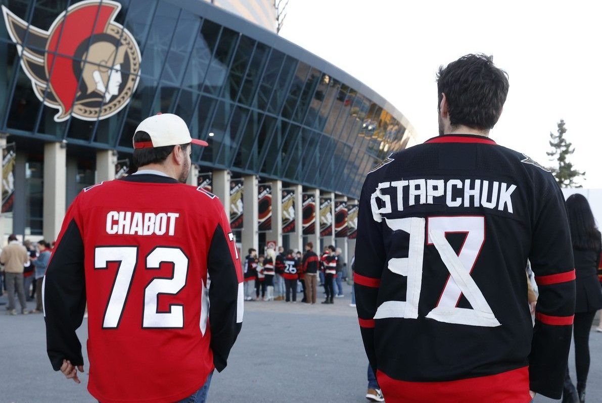 Ottawa Senators fans arrive for Wednesday's game at the Canadian Tire Centre after making changes to their Brady Tkachuk jerseys.