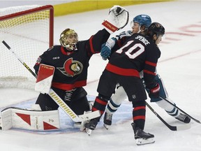 Samuel Ersson gloves down a puck.