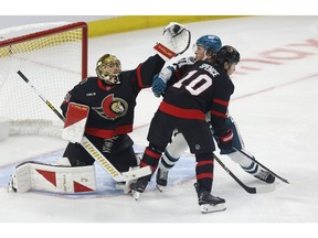 Samuel Ersson gloves down a puck.