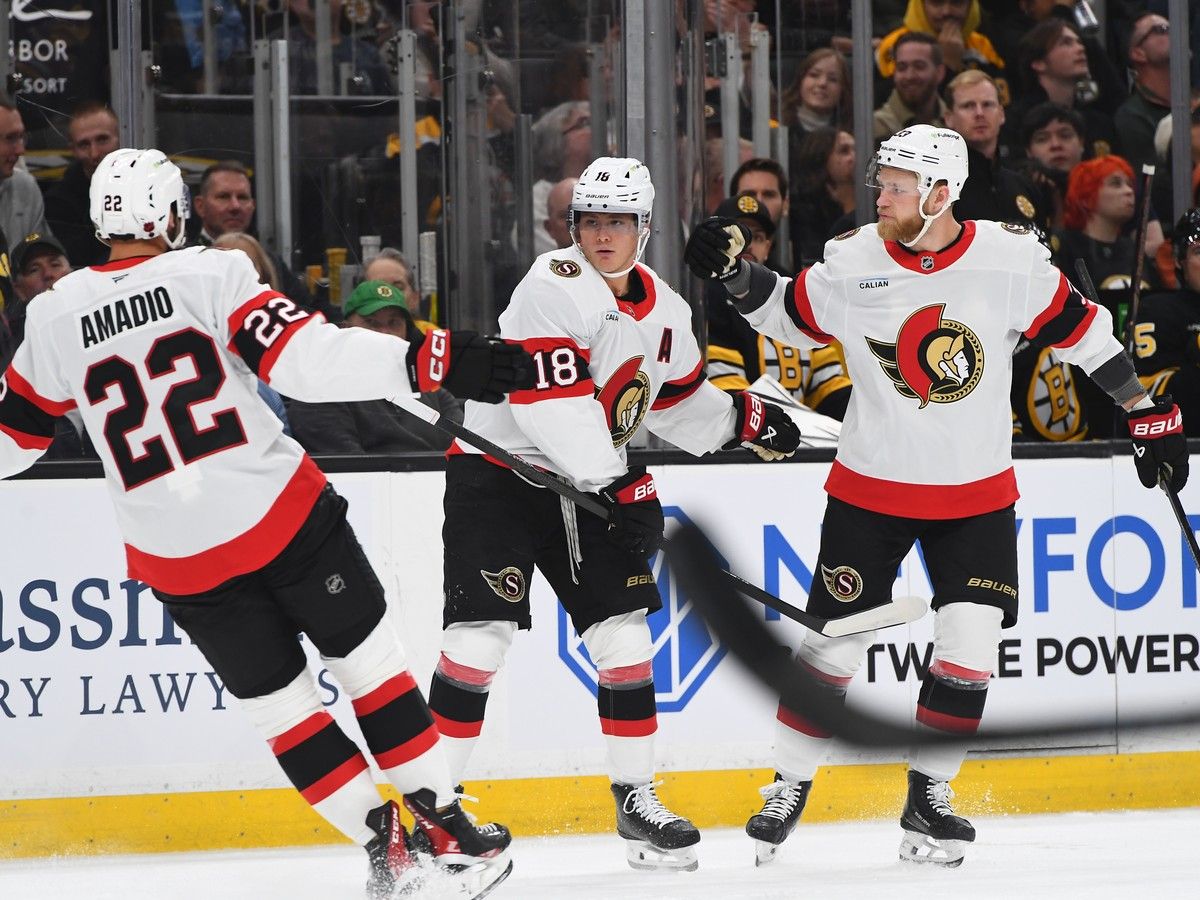 Michael Amadio, Tim Stutzle, centre, and Nikolas Matinpalo of the Ottawa Senators celebrate Stutzle's first-period goal against the Boston Bruins on Monday, Oct. 5, 2026, at the TD Garden in Boston.