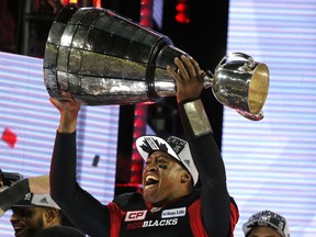 Henry Burris hoists the Grey Cup after the Ottawa Redblacks won the CFL championship in November 2016.