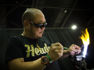 Dave Ro works on a glass skull at the Cannabis & Hemp Expo Saturday October 28, 2017 at the Shaw Centre.