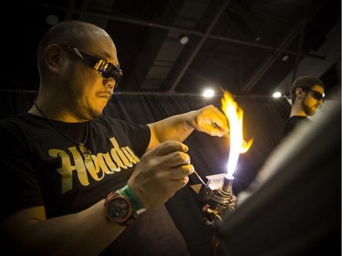 Dave Ro works on a glass skull at the Cannabis & Hemp Expo Saturday October 28, 2017 at the Shaw Centre.
