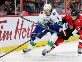 Ottawa's Bobby Ryan (right) battles for the puck with Vancouver's Christopher Tanev behind Vancouver's net during first-period action between the Ottawa Senators (red) and the Vancouver Canucks Tuesday (October 17, 2017) at Canadian Tire Centre. (Julie Oliver/Postmedia Network)