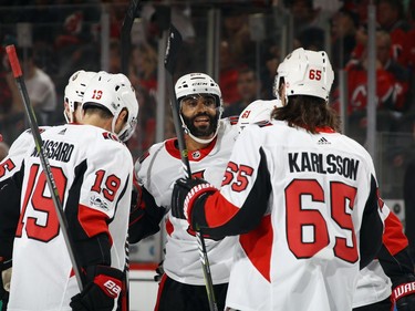 Johnny Oduya of the Senators, middle, celebrates his goal at 17:14 of the first period.  Bruce Bennett/Getty Images