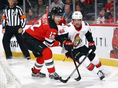Ben Lovejoyof the Devils checks Max McCormick of the Senators during the first period. Bruce Bennett/Getty Images