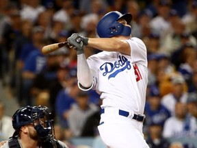 Joc Pederson of the Dodgers hits a solo home run during the seventh inning to provide an insurance run against the Astros in Game 6 on Tuesday night.  Ezra Shaw/Getty Images)