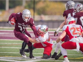 Gee-Gees defensive back Cody Cranston is pulled down by the Gryphons' Job Reinhart during Saturday's OUA playoff quarterfinal. Marc Bourget/marcbourget.ca