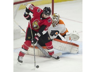 The Ottawa Senators' Alex Burrows tries to deflect the puck past Philadelphia Flyers goalie Michal Neuvirth.