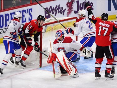 Senators forwards Alex Burrows (14) and centre Nate Thompson (17) celebrate a first-period goal by linemate Tom Pyatt, not in photo, against Canadiens netminder Al Montoya. THE CANADIAN PRESS/Sean Kilpatrick