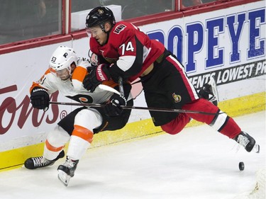 Ottawa Senators defenceman Mark Borowiecki collides with Philadelphia Flyers defenceman Shayne Gostisbehere.