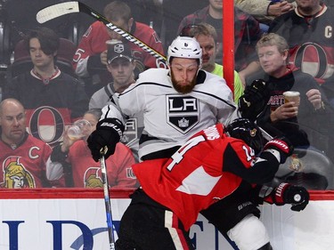 Ottawa Senators right wing Alexandre Burrows hits Los Angeles Kings defenceman Jake Muzzin during first period NHL action in Ottawa on Tuesday October 24, 2017. THE CANADIAN PRESS/Sean Kilpatrick