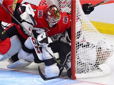 Los Angeles Kings right wing Dustin Brown gets shoved into the net by Ottawa Senators goalie Mike Condon during third period NHL action in Ottawa on Tuesday October 24, 2017. THE CANADIAN PRESS/Sean Kilpatrick