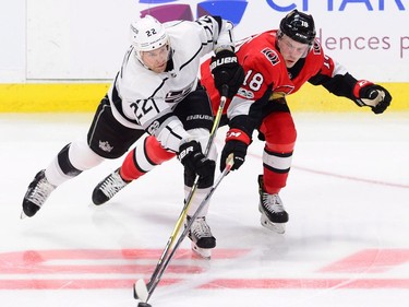 Los Angeles Kings centre Trevor Lewis, left, and Ottawa Senators left wing Ryan Dzingel fight for the puck during third period NHL action in Ottawa on Tuesday October 24, 2017. THE CANADIAN PRESS/Sean Kilpatrick