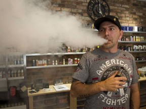 Mark Walsh, manager of My Own Clouds, vapes in the store in the Peterborough Mews.