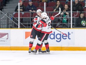 67's captain Travis Barron (19, left) and teammate Austen Keating celebrate one of the team's 11 goals in an 11-3 victory against the Saginaw Spirit in an Ontario Hockey League game in Ottawa on Saturday, Oct. 28, 2017. Valerie Wutti photo.