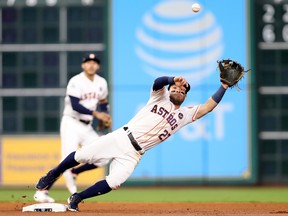 Jose Altuve of the Houston Astros reaches for a ball during Game 5 of the World Series at Minute Maid Park on October 29, 2017 in Houston.