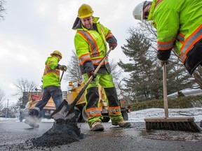 City of Ottawa road crews fill potholes along Southwood Dr in the west end.