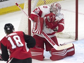 Detroit Red Wings goalie Jimmy Howard makes a save on a shot from Ottawa Senators' Ryan Dzingel during Thursday's game. (THE CANADIAN PRESS)