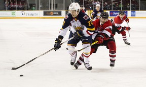 Ottawa 67’s defenceman Noel Hoefenmayer tries to get the puck from a member of the Barrie Colts. (ASHLEY FRASER/Postmedia Network)