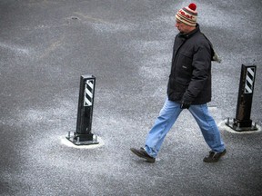 A man walks along the frosty ground at Lansdowne Park Saturday November 18, 2017.