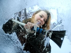 Eden Luciak has to put some muscle into scraping the layered, heavy ice off her car windows. (Feb 8, 2017).