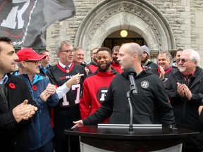 Ottawa Redblacks coach Rick Campbell  addresses the media alongside Mayor Jim Watson and city councillors, receiver Diontae Spencer and some other players before hoisting the team flag at City Hall Monday.