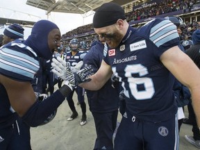 Toronto Argonauts players celebrate after clinching a trip to the the Grey Cup in Ottawa.