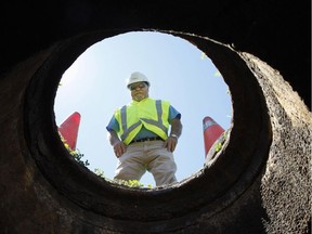 Rick Legault, Construction Technician with the city of Ottawa, stands above a sewer hole in Orleans Thursday. This photo is to go with Terry's story.n/a ORG XMIT: OttSherringPicJuly60
Tony Caldwell/Sun