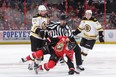 NHL linesman and Carp native Derek Nansen separates Senators’ Clarke MacArthur and Boston’s Joe Morrow. (GETTY IMAGES)