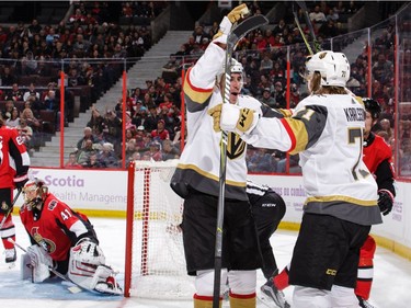 William Karlsson #71 of the Vegas Golden Knights celebrates his third-period goal against the Ottawa Senators with teammate Reilly Smith #19 as Craig Anderson #41 of the Ottawa Senators reacts.