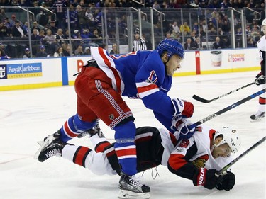 Jesper Fast #17 of the New York Rangers hits Derick Brassard #19 of the Ottawa Senators during the first period at Madison Square Garden on November 19, 2017 in New York City.  (Photo by Bruce Bennett/Getty Images)