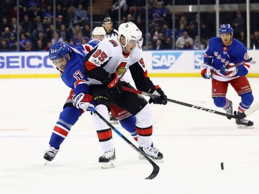 Matt Duchene #95 of the Ottawa Senators attempts to control the puck against Jesper Fast #17 of the New York Rangers during the first period at Madison Square Garden on November 19, 2017 in New York City.  (Photo by Bruce Bennett/Getty Images)