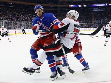 Brendan Smith of the Rangers interferes with the Senators' Mark Borowiecki in the third period of Sunday's game. Borowiecki was injured on the play and did not return to action, while Smith was assessed a major penalty and game misconduct. Bruce Bennett/Getty Images