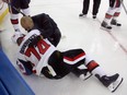 Mark Borowiecki #74 of the Ottawa Senators is attended to after being hit into the boards during the third period against the New York Rangers.