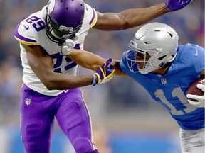 Marvin Jones #11 of the Detroit Lions fights off defender Xavier Rhodes #29 of the Minnesota Vikings after catching a pass during the first half at Ford Field on November 23, 2017 in Detroit, Michigan.