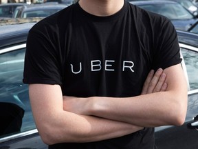 (FILES) This file photo taken on February 09, 2016 shows man wearing a shirt displaying the logo of smartphone ride service Uber during a protest by non-licensed private hire drivers blocking the Place de la Nation in Paris. Uber, the online platform for transportation, will offer from October 26, 2017 a free insurance to cover its drivers in case of accident during a ride, it announced on October 25, 2017. / AFP PHOTO / Geoffroy Van der HasseltGEOFFROY VAN DER HASSELT/AFP/Getty Images