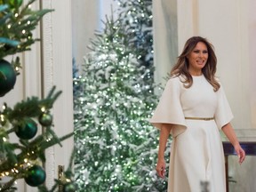 US First Lady Melania Trump walks into the East Room as she tours Christmas decorations at the White House in Washington, DC, November 27, 2017.