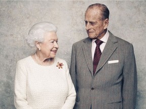 In this handout photo issued by Camera Press and taken in Nov. 2017, Britain's Queen Elizabeth and Prince Philip pose for a photograph in the White Drawing Room pictured against a platinum-textured backdrop at Windsor Castle, England. Britain's Queen Elizabeth II and Prince Philip are marking 70 years since they wed in London's Westminster Abbey. (Matt Holyoak/Camera Press via AP)