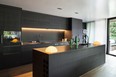 Modern kitchens with black cabinets are on-trend this year.