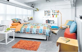 Kid-friendly artwork and accessories, a jaunty lamp, wicker floor chair and bedding featuring stylized cars give the room a vibrant look.