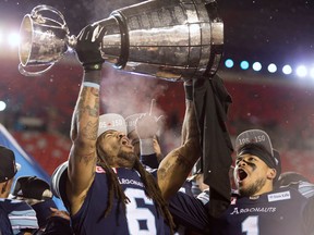 Toronto Argonauts linebacker Marcus Ball and running back Anthony Coombs celebrate with the Grey Cup on Nov. 26, 2017