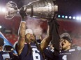 Toronto Argonauts linebacker Marcus Ball and running back Anthony Coombs celebrate with the Grey Cup on Nov. 26, 2017