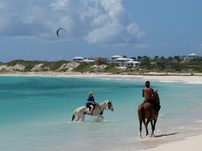 Take a horseback ride in the sea at one of the many beautiful beaches on Anguilla. JIM BYERS PHOTO