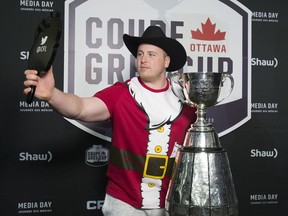Calgary Stampeders offensive lineman Quinn Smith poses with the Grey Cup during the CFL Grey Cup Media Day in Ottawa on Thursday, Nov. 23, 2017. The Calgary Stampeders will play the Toronto Argonauts in the 105th Grey Cup.
