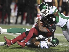 Roughriders linebacker Jeff Knox Jr. and a teammate drag down Redblacks running back William Powell during the game on Sept. 29.
 Powell rushed for 187 yards that night. THE CANADIAN PRESS/Justin Tang