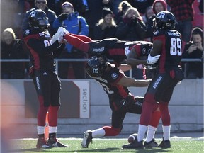 Juron Criner (86) and Dominique Rhymes (89) hold up Diontae Spencer (85) after his touchdown as teammate Greg Ellingson (82) limbos underneath him, in Eastern semifinal CFL action against the Saskatchewan Roughriders, in Ottawa on Sunday, Nov. 12, 2017. THE CANADIAN PRESS/Justin Tang